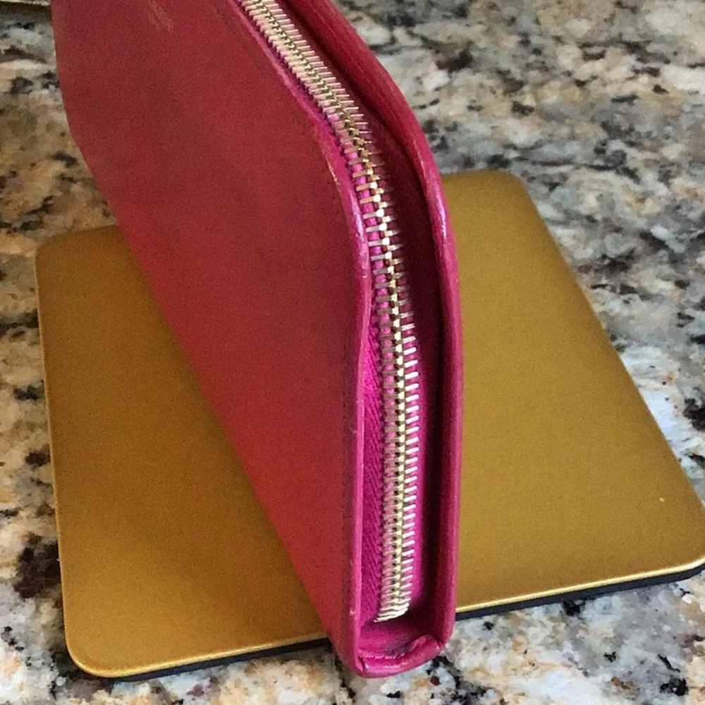 Saint Laurent. pink zippy lambskin wallet gold tone hardware